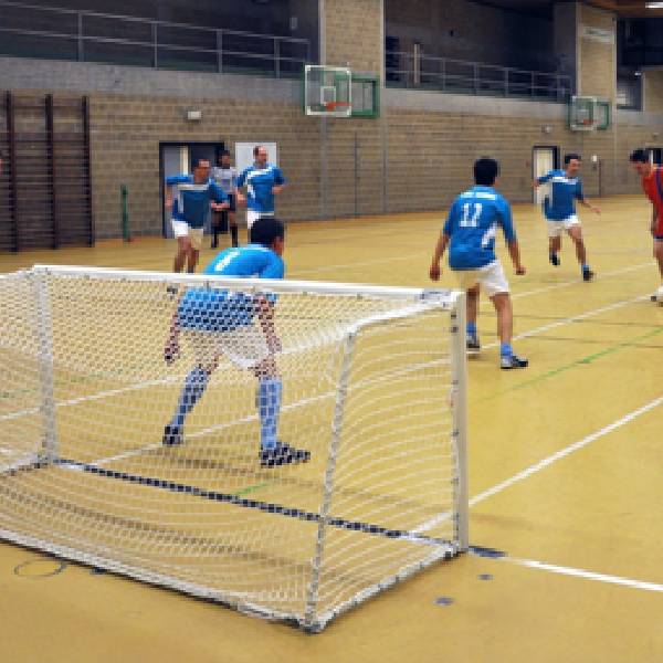 A 5-a-side football game is performing in the indoors.