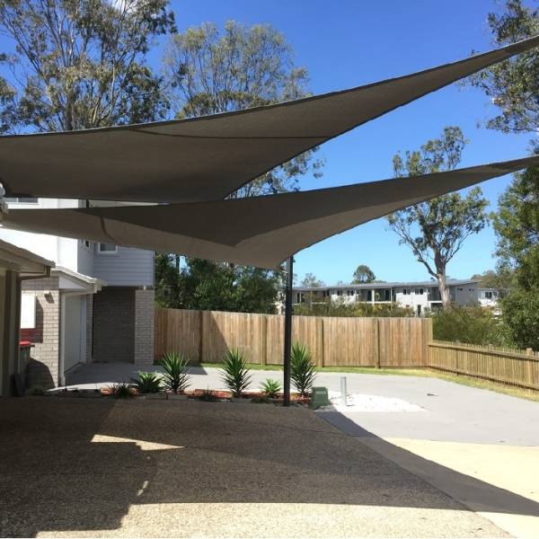 Sun shade sail installed above the carport