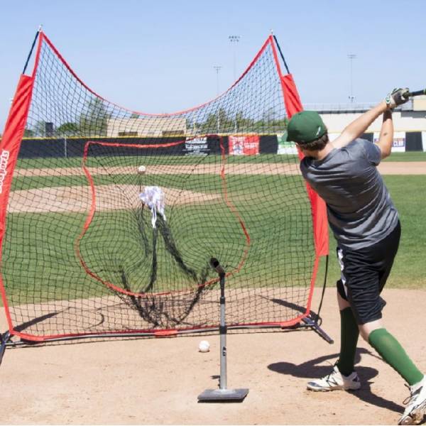 A man is practicing his baseball hitting skills.