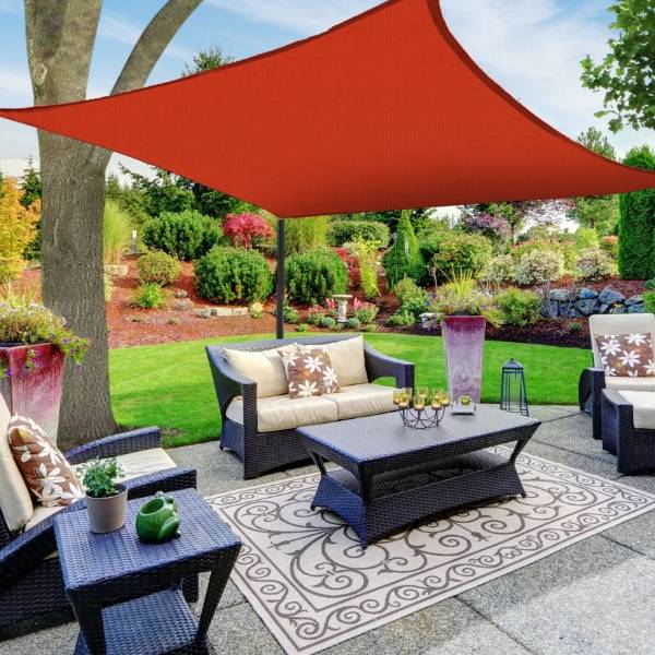 Red sun shade sail in the yard
