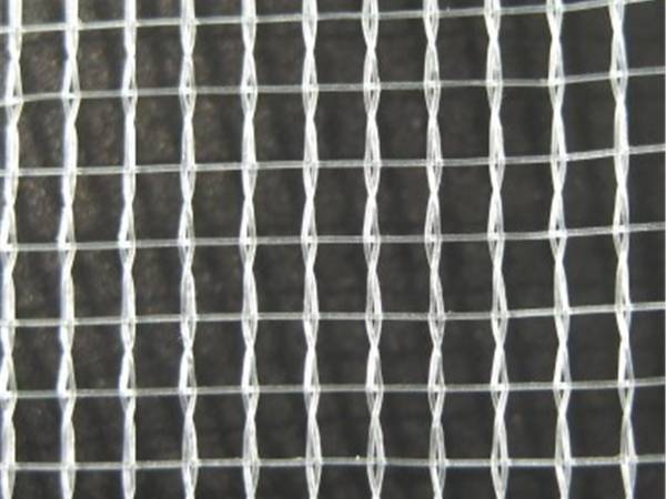 Transparent Leno woven hail netting on a black background