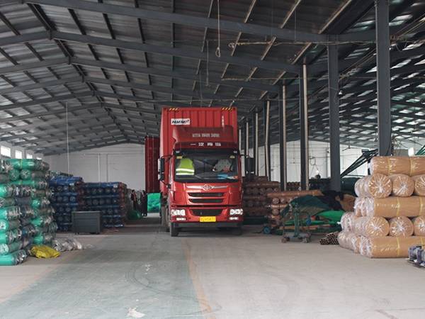 A truck is parked in the warehouse for loading.