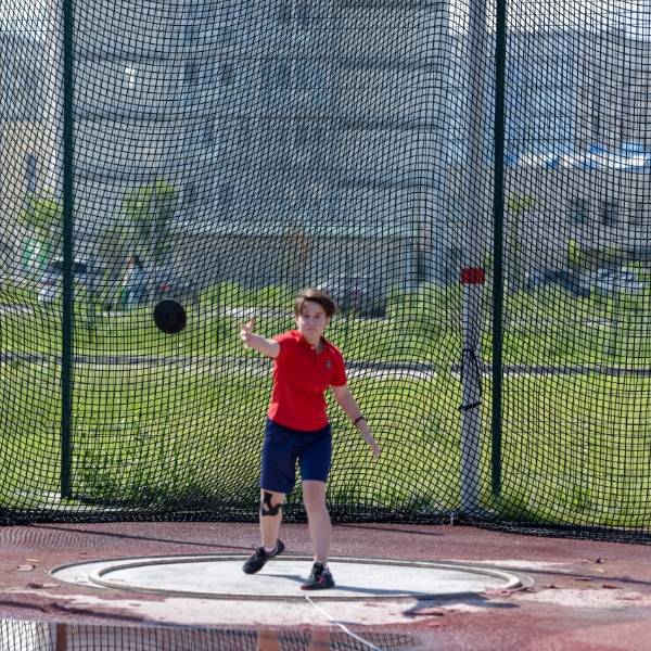 A student is practicing discus throw skills.