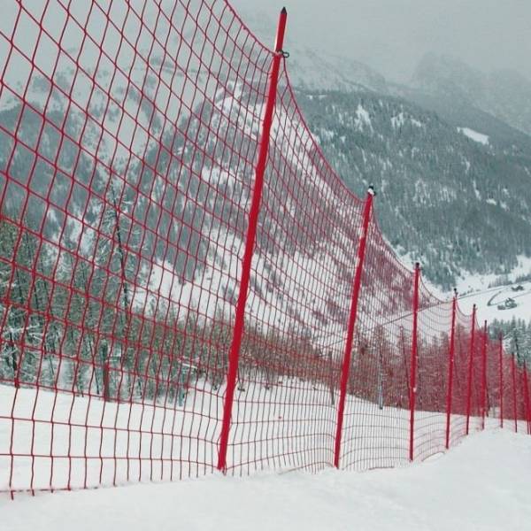 Red sports perimeter net is installed around the ski field.