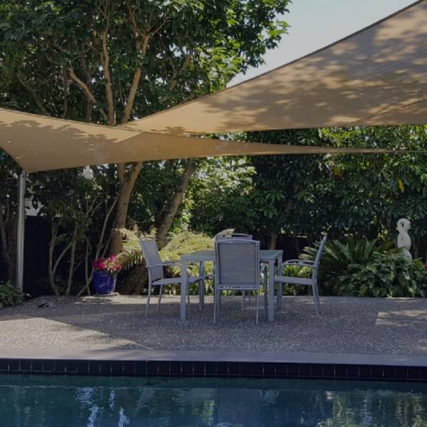 Sun shade sail installed on the swimming pool