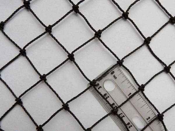 A rule is used to check the tennis net mesh size.