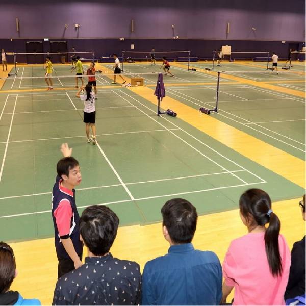 Players are taking part in the badminton training in the field.